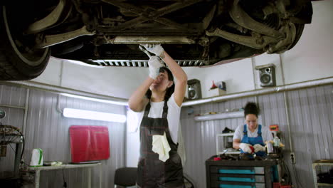 woman repairing car