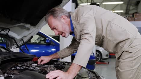 Mechanic-checking-car-engine-oil-and-showing-thumbs-up