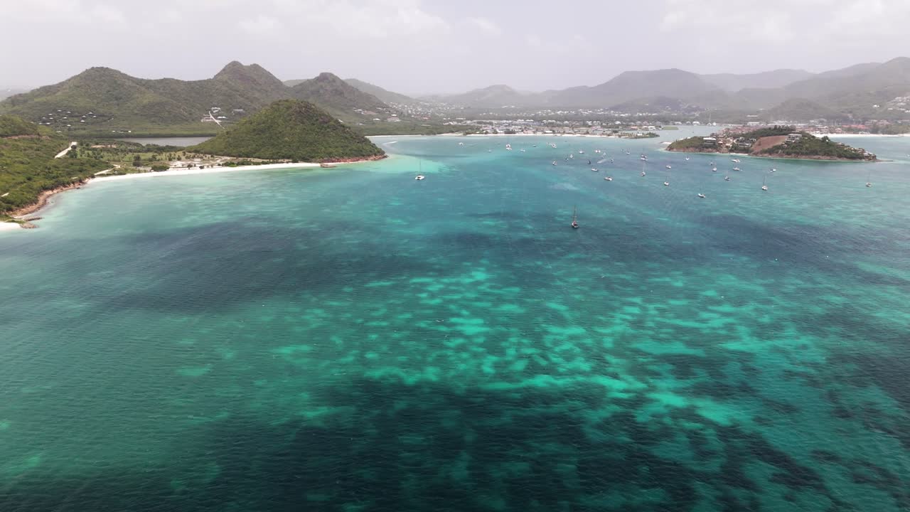 Aerial View of a Tropical Island with Boats and Clear Turquoise Water