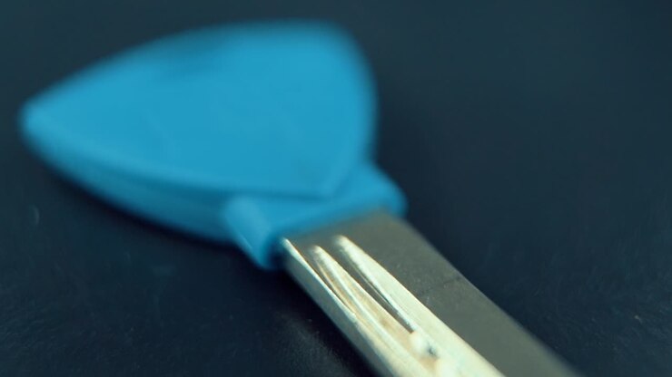 A cinematic close up Macro slide shot of a metal key, studio lighting, slow motion, 120 fps, Full HD