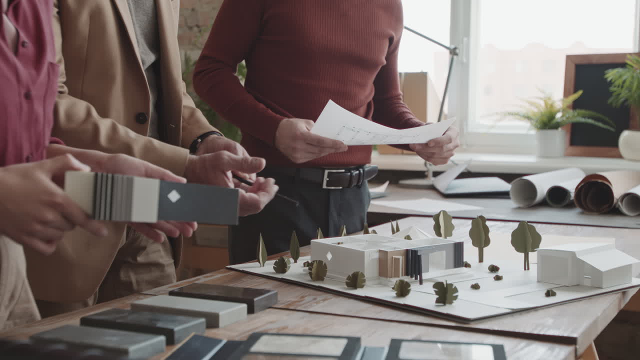 Midsection Of Architects With 3D House Layout