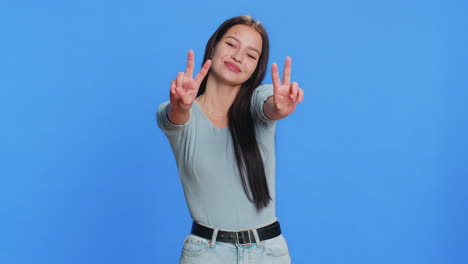 happy smiling caucasian woman showing victory sign hoping for success and win doing peace gesture
