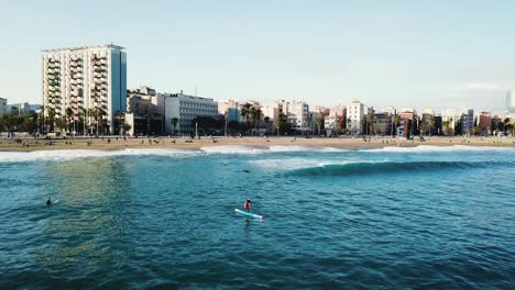 stand up paddleboarding en la playa de barcelona