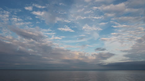 calm and peaceful view of lake ontario with soft clouds and clear blue skies