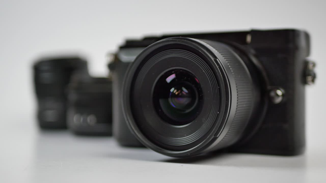 A black  mirrorless camera and lens on white background ,