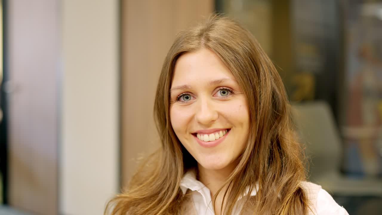 Young coworker smiling at camera in the office