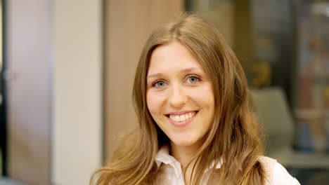 young coworker smiling at camera in the office