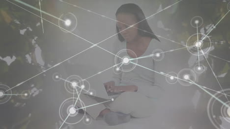 Animation-of-network-of-connections-over-african-american-woman-reading