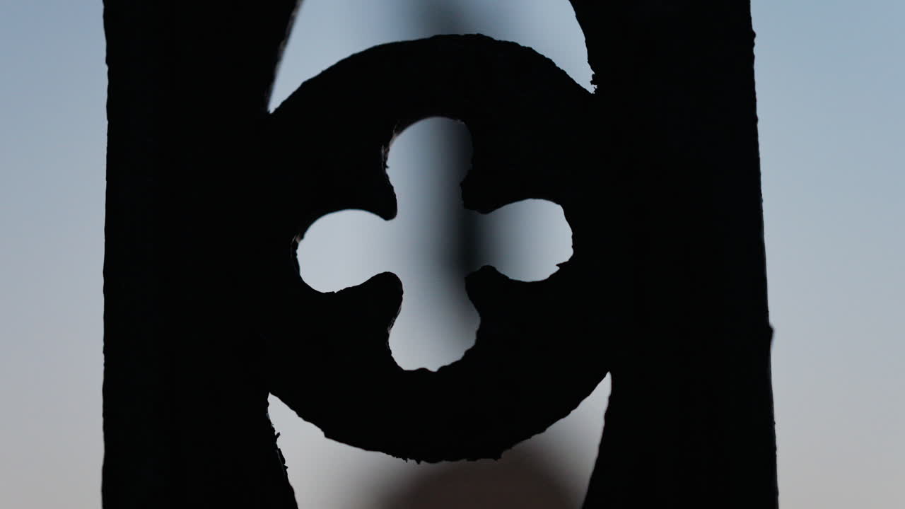 Chisinau, Moldova - June 15, 2025: Stephen the Great statue seen through the out-of-focus curves of a wrought-iron fence