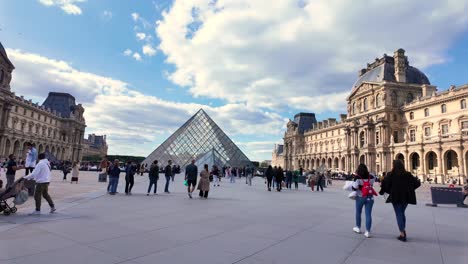 louvre pyramid museum square paris france tourist attraction busy during the day