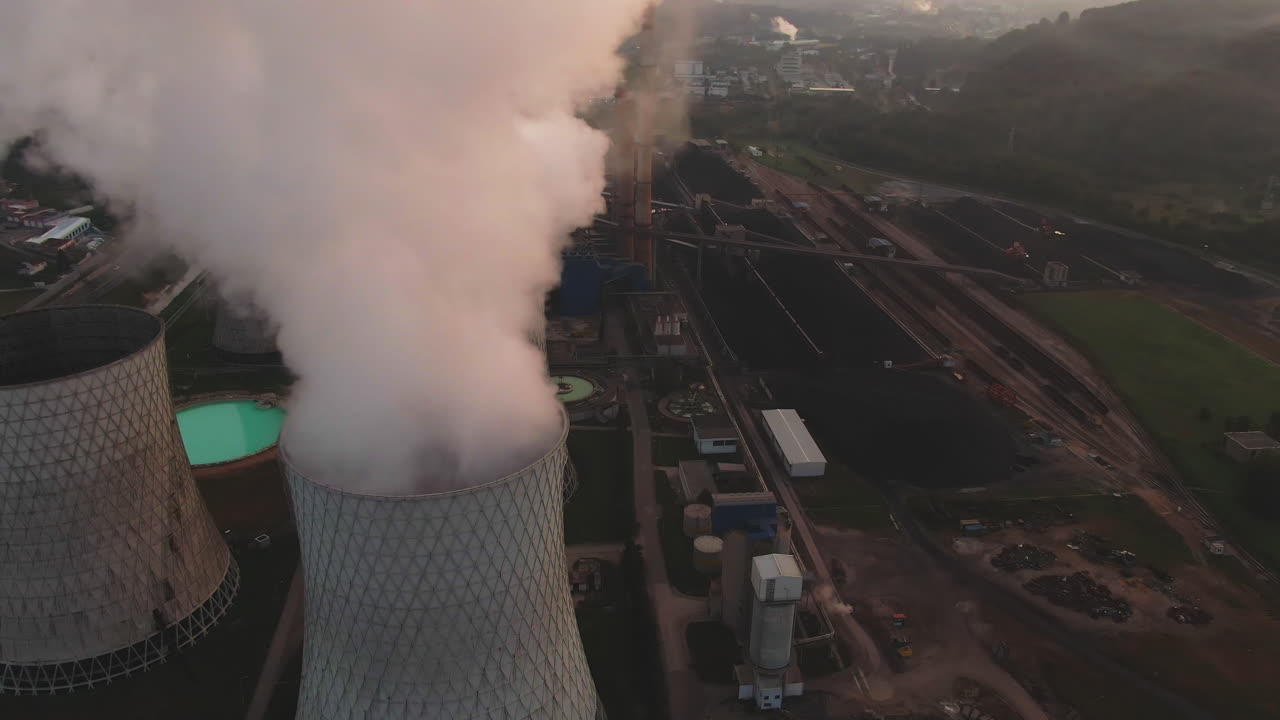 Aerial View of Power Plant Cooling Towers and Smoke Emission