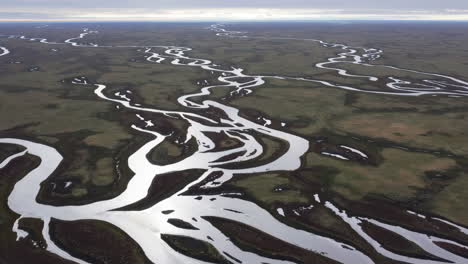 aerial view of a braided river system winding through a vast landscape