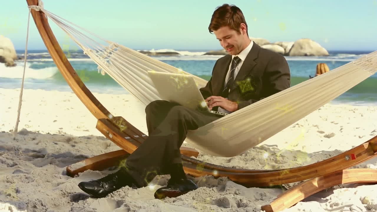 In hammock on beach, businessman in suit working on laptop with animation