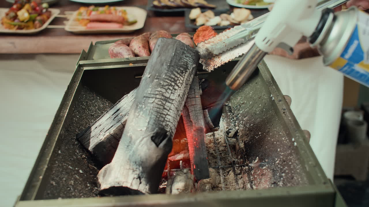 Anonymous Person Burning Coals in Barbecue with Gas-lighter