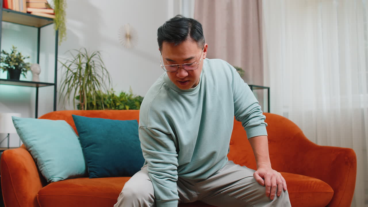 Asian man weight lifting dumbbells training biceps workout burning fat calories training strength