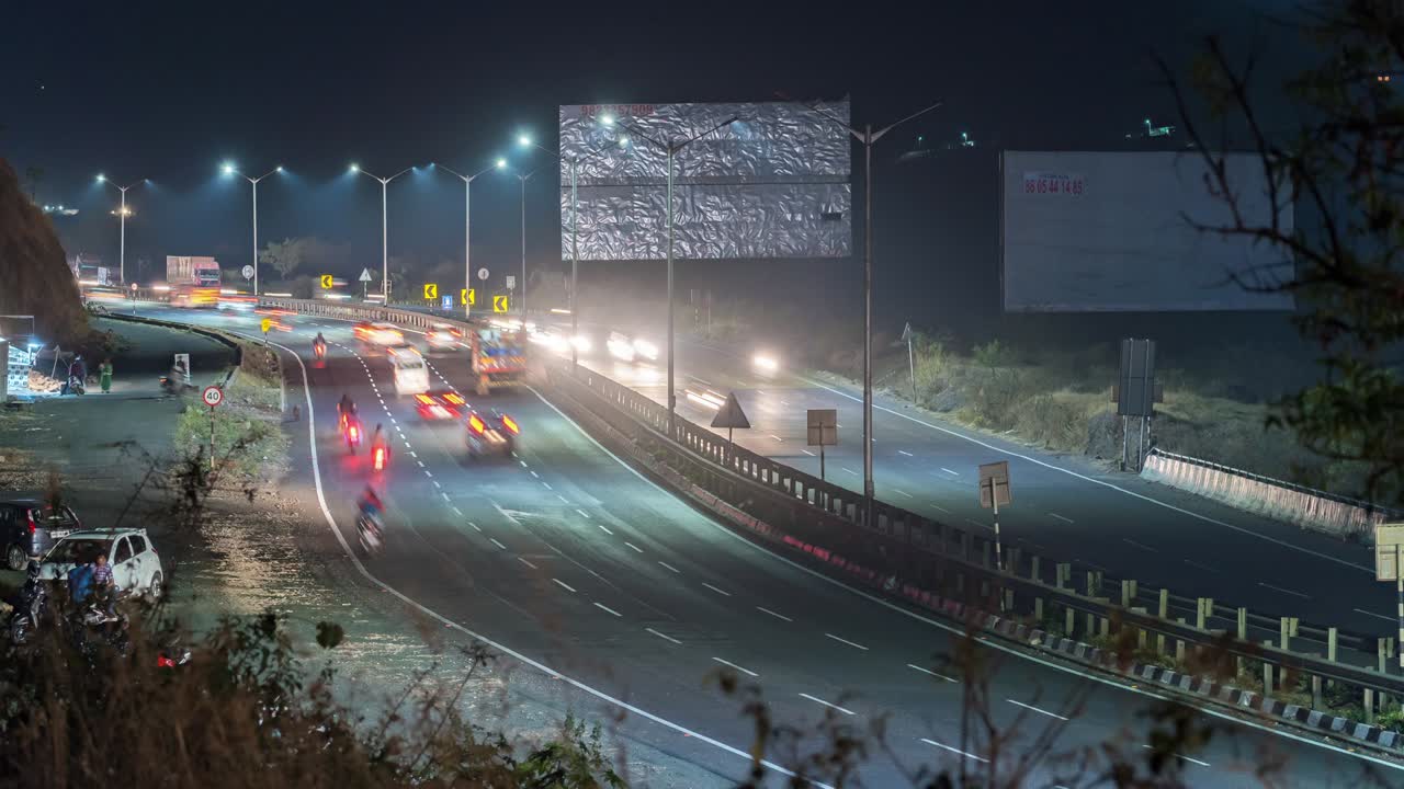 Time lapse of busy high speed vehicle traffic at night time on Mumbai - Pune - Bengaluru S shaped national highway