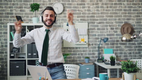 happy man dancing in modern office
