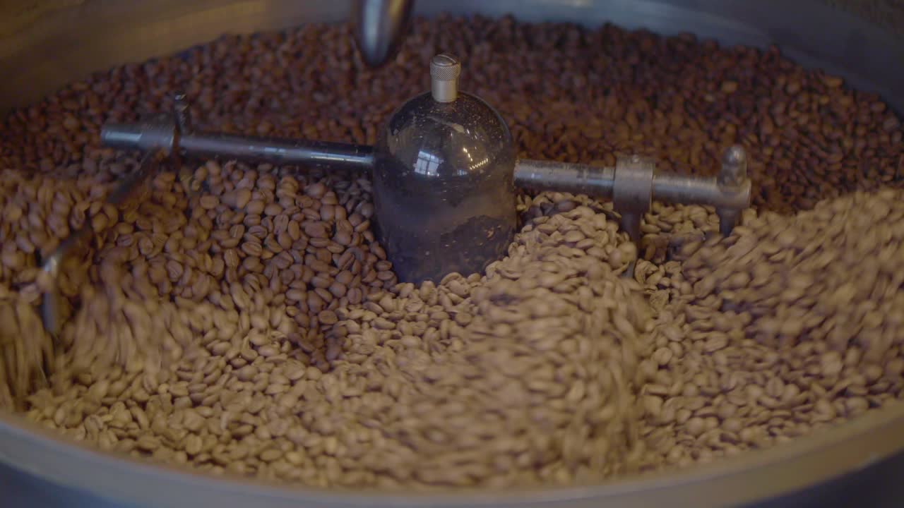 Close Up Of Coffee Beans Being Roasted In A Coffee Roaster