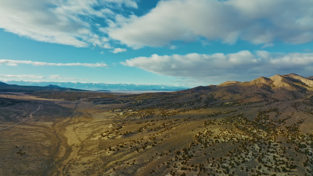 Drone shot of Nevada high desert early in the morning. Camera slowly flies past mountains