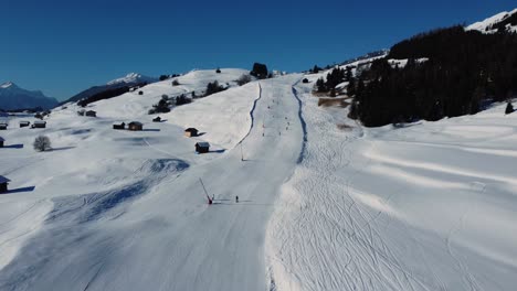 perfect downhill ski slope on sunny day in austria, aerial