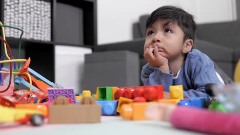 wo-years-old-mexican-baby-boy-watching-tv-laying-on-the-floor