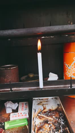 burning candle at a shrine