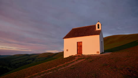 small chapel on a hilltop at sunrise/sunset
