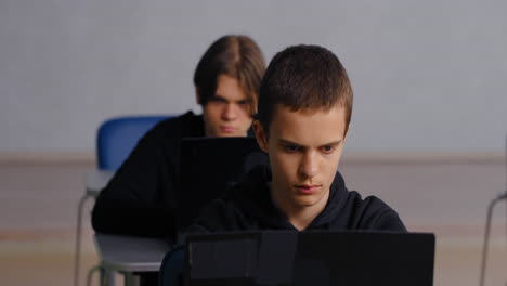 Students working in a classroom with laptops