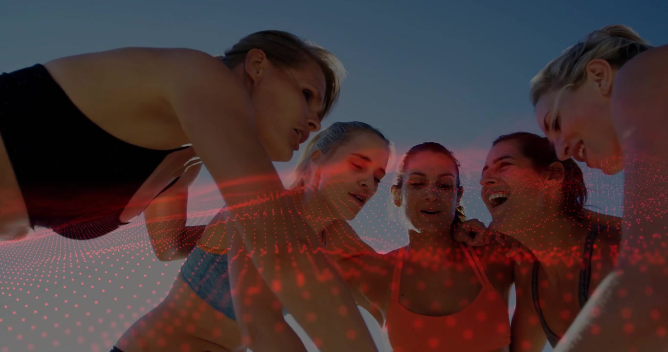 Five women forming huddle bringing hands causing red dot overlay lifting volleyball preparing play