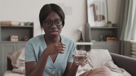 african woman taking a pill