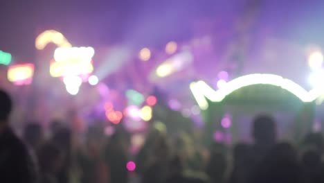 Blurry-lights-of-carnival-fair-party-at-night-with-people