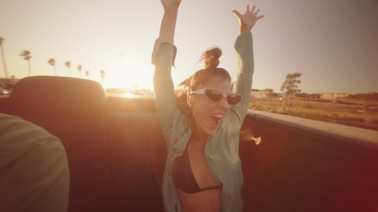 Woman enjoying a convertible ride on a road trip