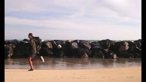 African-American-male-runner-jogging-on-the-beach-4k