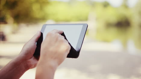 man sharing content digital tablet computer ipad outdoors in nature