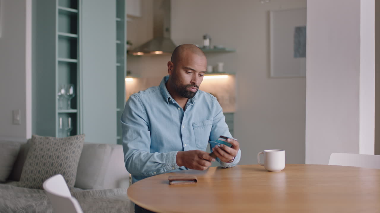attractive man using smartphone shopping online spending money on credit card mobile banking app with digital currency enjoying financial freedom