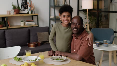 Grandfather-and-grandson-hugging-at-home