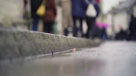 Closeup-of-curbstone-during-rainy-day-in-munich