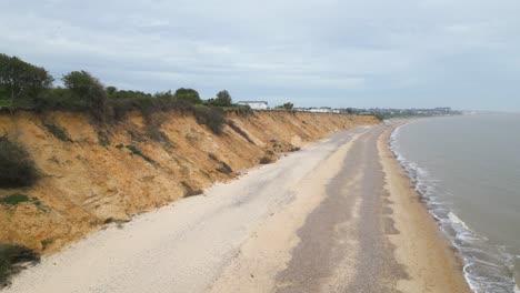 Toma-De-Drone-De-Una-Carretera-Vacía-A-Lo-Largo-De-La-Playa-De-Pakefield-En-Loweroft,-Inglaterra