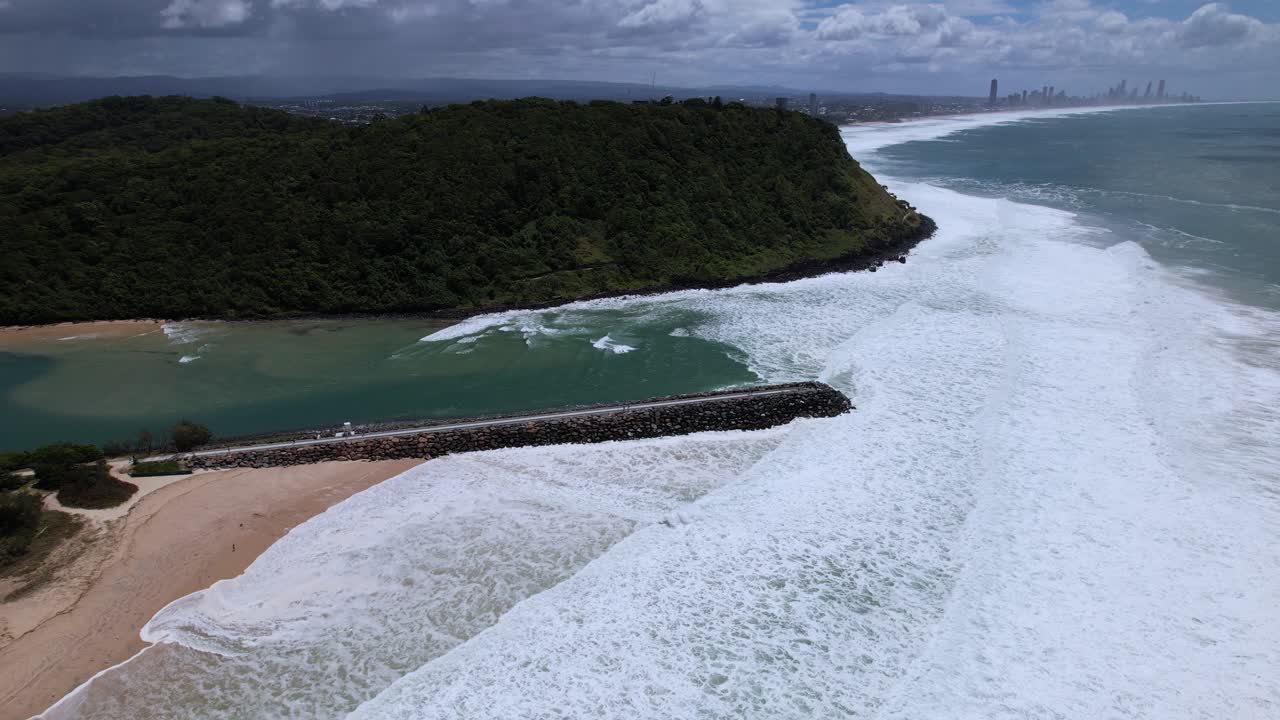 Foamy Waves Breaking On Tallebudgera Seawall During Hurricane Alfred In Burleigh Headland In QLD Australia. Aerial Drone Shot