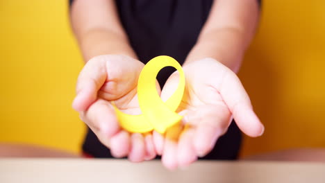 suicide prevention day, sarcoma, bone, bladder and childhood cancer awareness month, yellow ribbon for supporting people living and illness