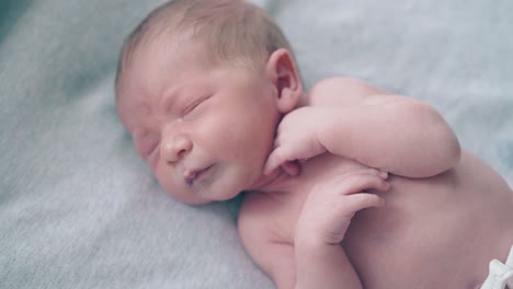 crying-infant-with-fair-hair-lies-on-baby-changing-table