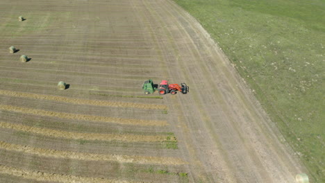 birds eye view ot a tractor baling hay in saskatchewan canada