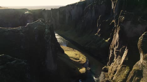 famous canyon in iceland, fjaðrárgljúfur, aerial establisher in golden sunset