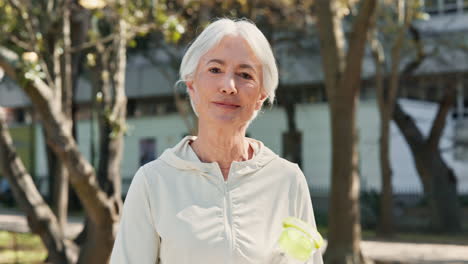 smiling senior woman in sportswear enjoying her workout in the park