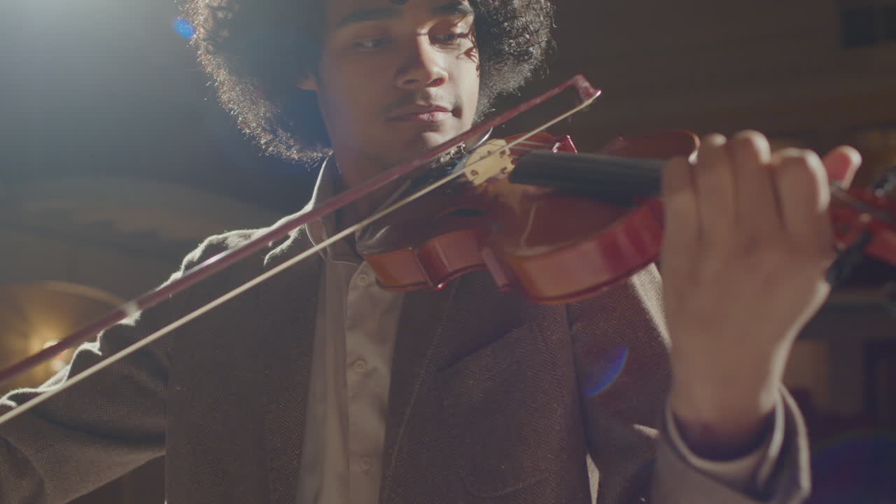 Young African American Man Playing Violin on Stage