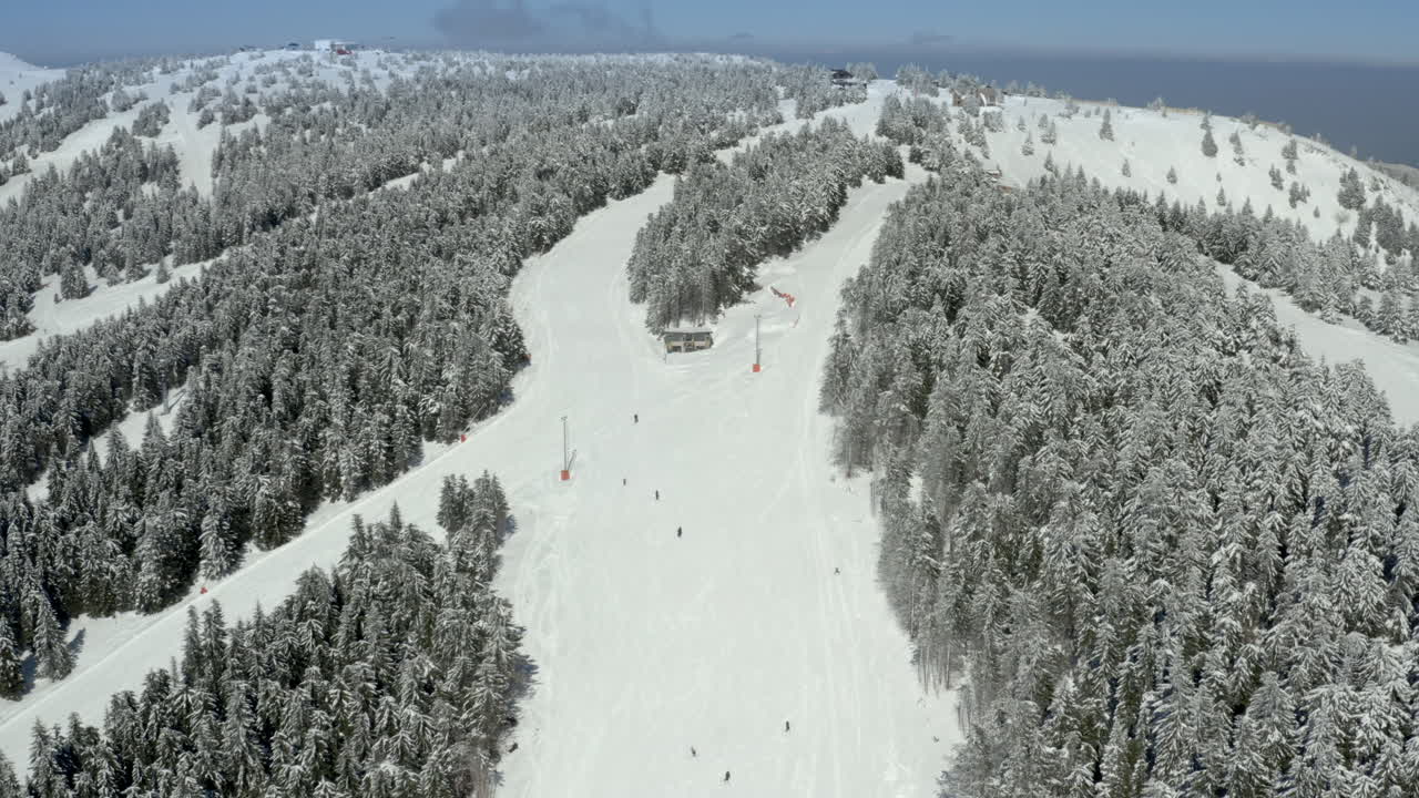 Aerial view of a snowy ski resort with skiers