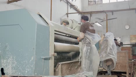 workers on the production line processing animal hides in a leather manufacturing factory.