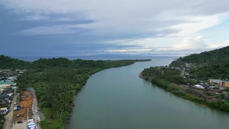 Aerial-view-of-large-river-dividing-the-idyllic-towns-of-Bato,-Catanduanes,-Philippines