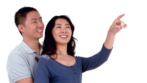 smiling asian woman pointing over the screen