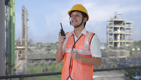 happy indian architect giving directions on walkie talkie